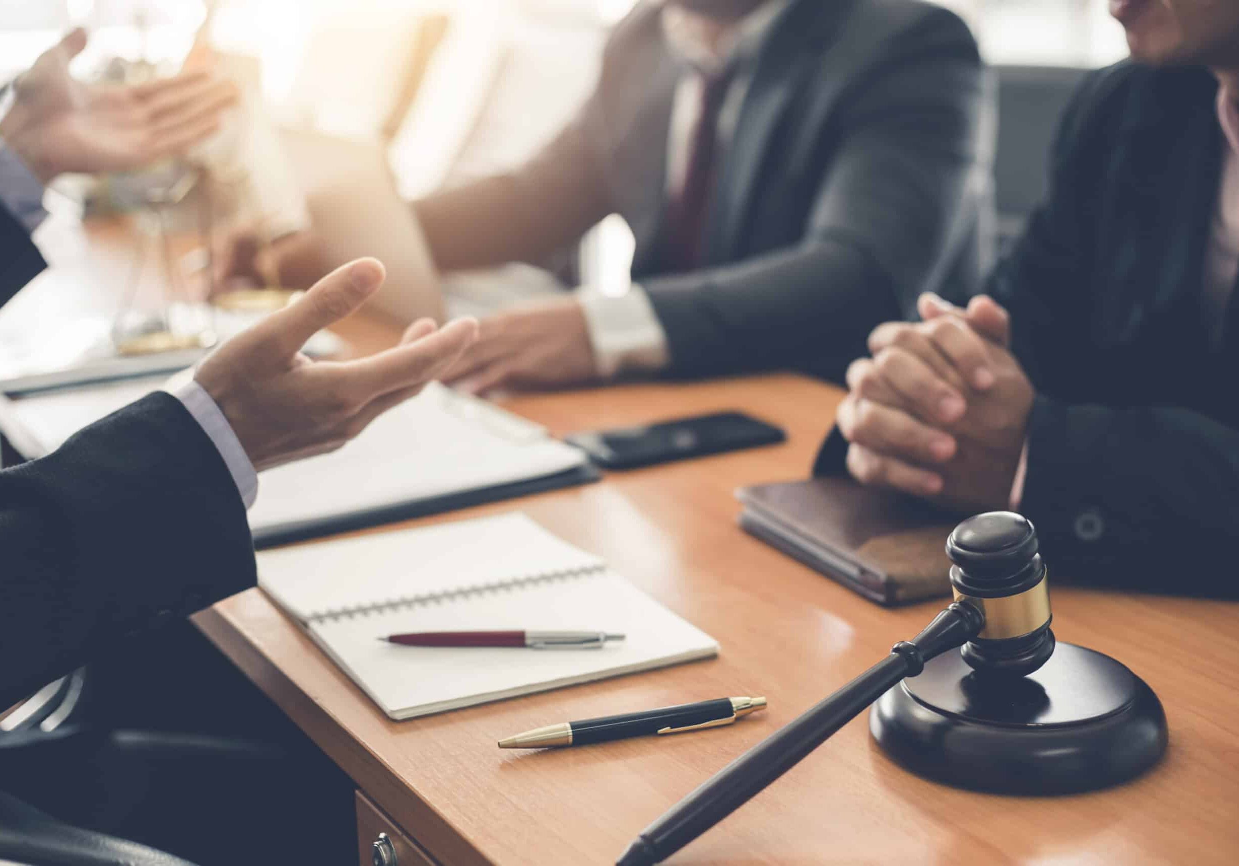 Businessman and lawyer discuss lawsuits in the office.